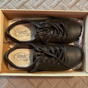 1️⃣ black pair of Clark’s shoes.